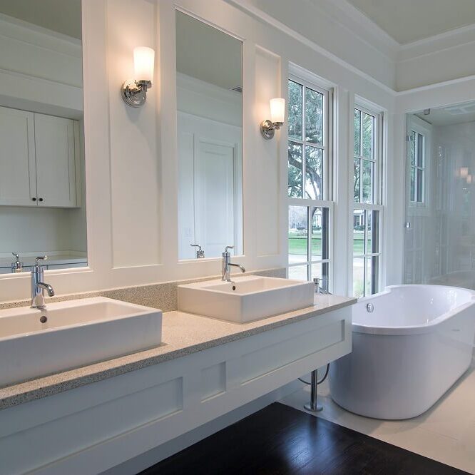 Modern bathroom with sinks and bathtub.